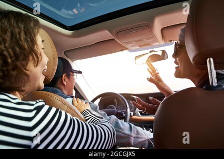 group of asian friends enjoying a sightseeing trip by car Stock Photo