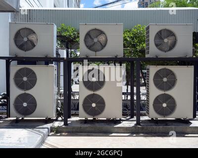 Group of air conditioning compressor unit installed outside the building. Outdoor air condensers installed stacking. Stock Photo