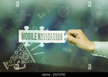 Text sign showing Mobile Navigation. Conceptual photo graphical user interface used to aid the vehicle driver Hand Holding Jigsaw Puzzle Piece Stock Photo