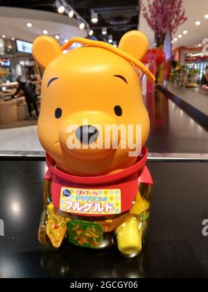 A cute Winnie the Pooh jar filled with colorful artificially flavored fruit gelatin, Jello, jelly at a mall in Hong Kong Stock Photo