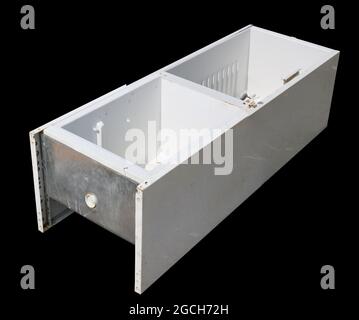 Broken refrigerator in a garbage dump isolated on black Stock Photo
