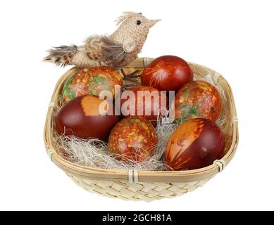Easter handmade painted eggs and rope chicken in basket. Isolated on white Stock Photo