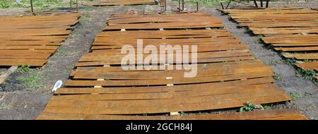 Rusty iron tapes for building a rural fence lie on the ground Stock Photo