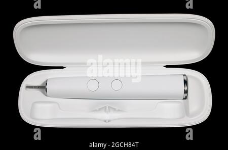 Electric toothbrush in a plastic case isolated on black. Mass production Stock Photo