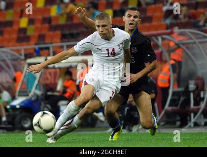 BUCHAREST, ROMANIA - AUGUST 9, 2012: Mihai Roman of Rapid (L) pictured in action during the second leg of the 2012/13 UEFA Europa League Third Qualifying Round game between Rapid Bucuresti and FC Heerenveen at National Arena. Stock Photo