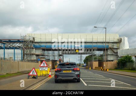 A temporary Traffic light controlled  single lane road working during works on an overhead bridge Stock Photo