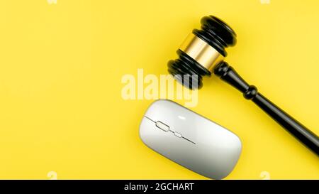 Judge's gavel on light background, top view. Law concept. Selective focus on gavel on a yellow background. Stock Photo