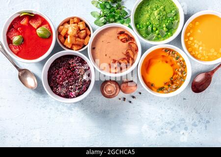 Vegan soup variety, fresh summer detox menu, top shot with a place for text. Colorful vegetable cream purees Stock Photo