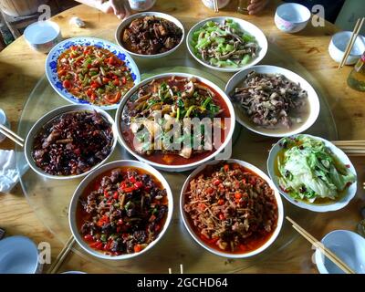 A banquet style meal at a family home on a Lazy Susan round table in the ancient, beautiful Lizhuang Stock Photo