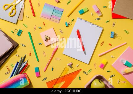 Set of school supplies, stationery accessories. Education, freelance concept. Bright yellow wood background. Flat lay or top view Stock Photo