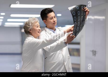 Doctors discussing X-ray image Stock Photo