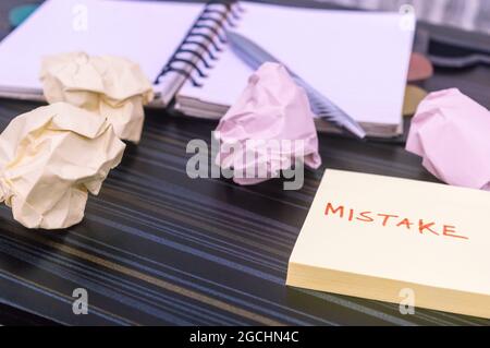 Mistake written on sticky notes. Learning, wrong, blooper, error message, regret sayings background. Fault, defect, careless, lesson correction and re Stock Photo