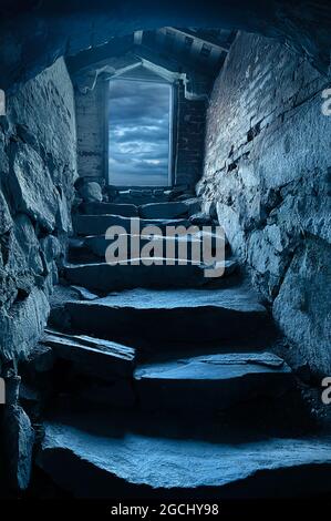 Dark steep stone stairs to cellar dungeon Stock Photo
