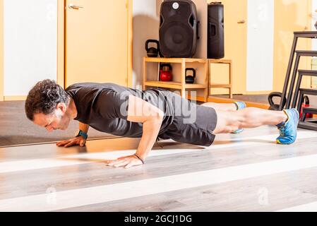 Adult man doing push ups in helth club Stock Photo