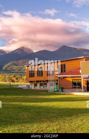 Bansko, Bulgaria - October 31, 2020: Autumn view with gondola lift station and Pirin mountain peaks, pink morning clouds Stock Photo