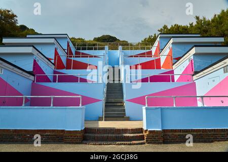 Blue and pink abstract concrete building with trees in the background Stock Photo