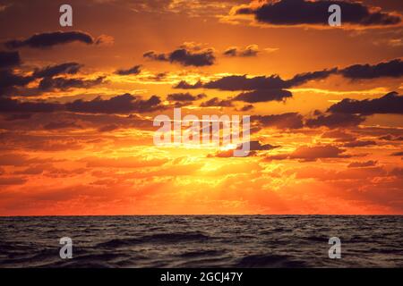 Dramatic cloudscape over the sea, sunrise shot Stock Photo