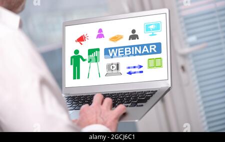 Webinar concept shown on a laptop used by a man Stock Photo