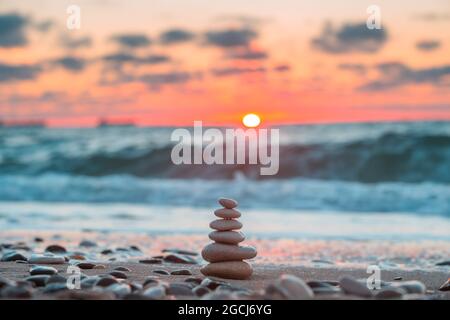 Stones balance on beach, sunrise shot Stock Photo