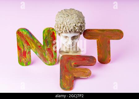 NFT Non-Fungible token. Concept for blockchain system. Classical statue and Non Fungible Token symbol on a pink background. Crypto art concept Stock Photo