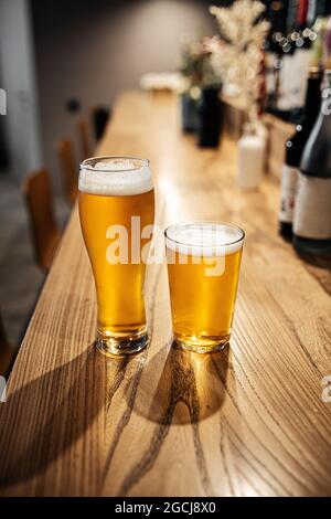 Two glasses of japanese light beer on a bar desk Stock Photo