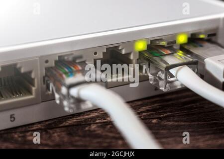 Internet router with connected wires close-up selective focus Stock Photo