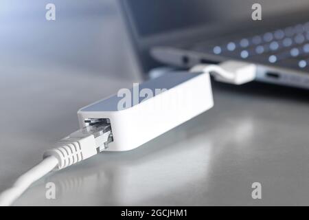 adapter for connecting an internet cable to a laptop closeup. usb - rj45 Stock Photo