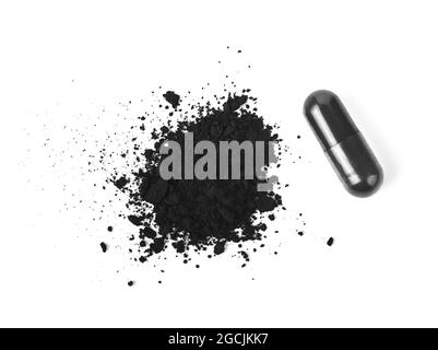 Charcoal capsules and powder isolated on white background. Top view Stock Photo