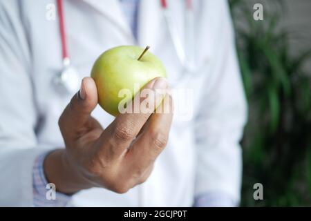doctor hand holding green apple close up  Stock Photo