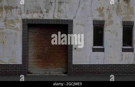 Rusted roller garage door in a building. Stock Photo
