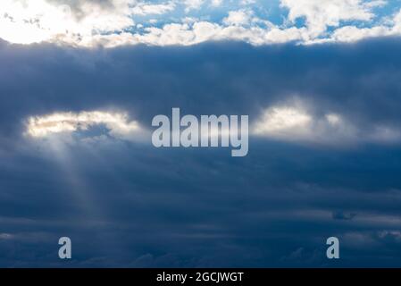 Rays of light shining throug dark clouds.Beautiful dramatic sky with sun rays.dramatic sky sun rays. Stock Photo