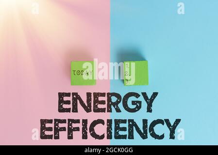 Sign displaying Energy Efficiency. Word for reduce the amount of energy required to provide product Two Objects Arranged Facing Inward Outward On a Stock Photo