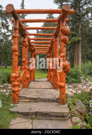 A bridge made from burled logs in Cascade public gardens in Banff, Alberta, Canada Stock Photo