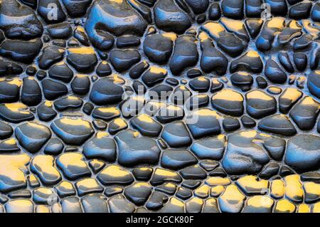 Rough textured background of rock sedimentary of blue and yellow colors with uneven surface Stock Photo