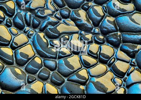 Rough textured background of rock sedimentary of blue and yellow colors with uneven surface Stock Photo