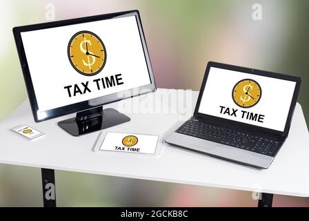 Tax time concept shown on different information technology devices Stock Photo