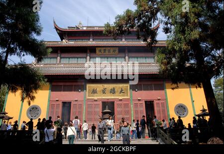 Lingyin Temple also known as the Temple of the Soul's Retreat in Hangzhou, China. View of the Maravira Hall the main hall of the temple with people. Stock Photo