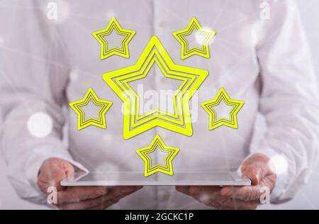 Quality concept above a tablet held by a man in background Stock Photo