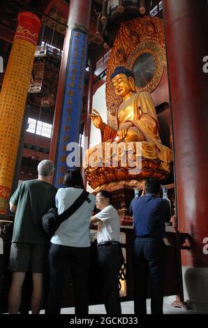 Lingyin Temple also known as the Temple of the Soul's Retreat in Hangzhou, China. Statue of Buddha in the Maravira Hall (main hall) at the temple. Stock Photo