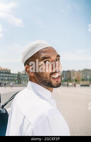 Islamic male in authentic white clothes while standing Stock Photo