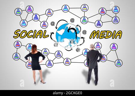 Social media concept drawn on a wall watched by business people Stock Photo