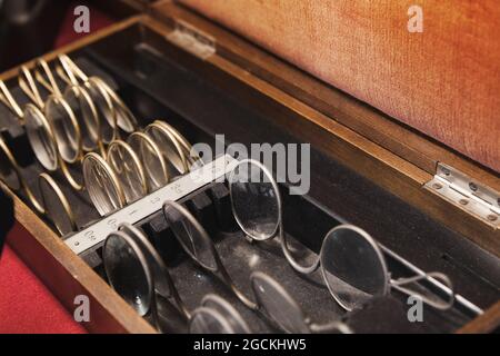 Vintage glasses are in a wooden box, optometrist set, close up photo with selective soft focus Stock Photo