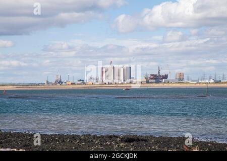 Hartlepool Nuclear Power Station and decommisioned oil rigs at Seaton Port as viewed from South Gare,Redcar,England,UK Stock Photo