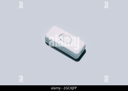 Conceptual shot of an electric switch button isolated on grey background Stock Photo
