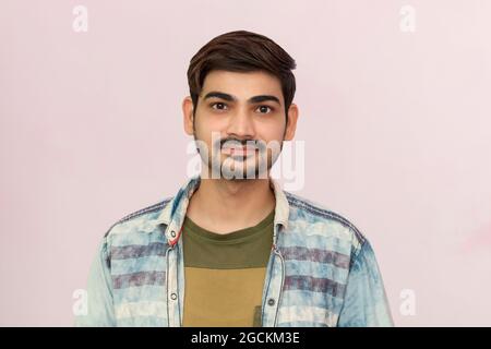 young boy portrait looking at camera with happiness on isolated background. Stock Photo