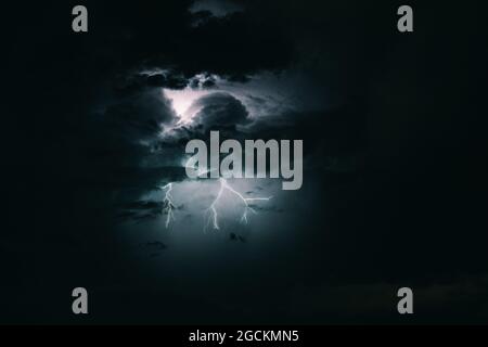 Storm sky with lightning among the dark and dramatic clouds Stock Photo
