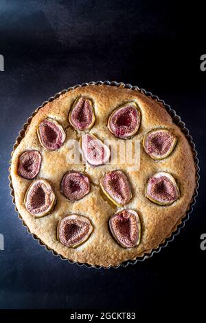 From above of sweet pie with figs served in baking dish on table Stock Photo