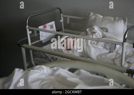 The newborn baby girl lies on her bed after a scheduled caesarean section delivery amid the coronavirus (COVID-19) pandemic in Istanbul, Turkey, on Monday, August 9, 2021. (Photo by Ilker Eray/GocherImagery/Sipa USA) Stock Photo