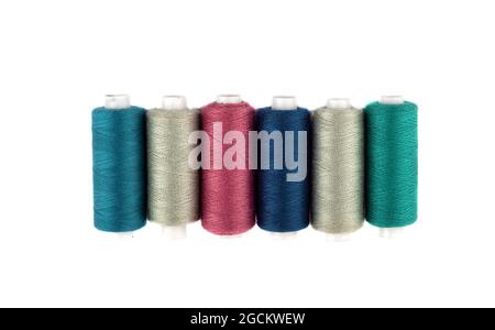 Top view of spools of colored thread on a white background. Copy space. Stock Photo