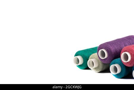 Spools of thread isolated on white with space for text. Horizontal positioning of the frame. The spools are on the right side. Stock Photo